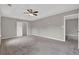 Spacious bedroom offers neutral walls, carpet flooring, ceiling fan, and multiple entryways at 3885 Riverview Chase Blf, Ellenwood, GA 30294