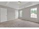 Cozy bedroom featuring a tray ceiling, neutral walls, and ample natural light at 3885 Riverview Chase Blf, Ellenwood, GA 30294