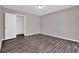 Bedroom featuring laminate flooring, neutral paint, and a walk-in closet at 3885 Riverview Chase Blf, Ellenwood, GA 30294