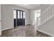 Elegant foyer featuring stylish flooring, a sleek front door with decorative glass, and a staircase at 3885 Riverview Chase Blf, Ellenwood, GA 30294