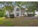 Charming two-story home with light siding, complemented by well-manicured hedges and a welcoming entrance at 3885 Riverview Chase Blf, Ellenwood, GA 30294