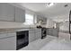 Well-equipped kitchen boasts gray cabinetry, stainless steel appliances, and tiled floors at 3885 Riverview Chase Blf, Ellenwood, GA 30294