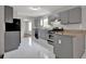 Well-lit kitchen features gray cabinets, stainless steel appliances, and granite countertops at 3885 Riverview Chase Blf, Ellenwood, GA 30294