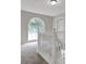 Bright landing featuring an arched window, natural light, and a white wooden staircase railing at 3885 Riverview Chase Blf, Ellenwood, GA 30294