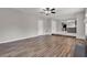 Hardwood floors in a living room with a fireplace, adjacent to an open kitchen at 3885 Riverview Chase Blf, Ellenwood, GA 30294