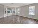 Bright living room featuring hardwood floors, many windows for natural lighting, and neutral walls at 3885 Riverview Chase Blf, Ellenwood, GA 30294