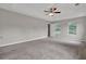 Spacious main bedroom with ceiling fan, tray ceiling, carpeting, and good natural light at 3885 Riverview Chase Blf, Ellenwood, GA 30294