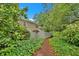 A pathway leading to the home that is surrounded by lush greenery and mature trees at 4 Mount Vernon Cir, Atlanta, GA 30338