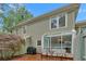 Exterior view of the home with a cozy brick patio, a charming sunroom and beautiful landscaping at 4 Mount Vernon Cir, Atlanta, GA 30338
