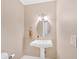 This bathroom features a pedestal sink with oval mirror at 4 Mount Vernon Cir, Atlanta, GA 30338