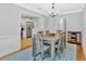 Elegant dining room with wainscoting, chandelier, and a view of the updated kitchen area at 4 Mount Vernon Cir, Atlanta, GA 30338