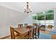 Sunlit dining room with a wooden table, chandelier, and views of the outdoor area at 4 Mount Vernon Cir, Atlanta, GA 30338