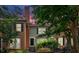 Charming townhome exterior featuring brick accents, green siding, and a beautifully landscaped walkway at 4 Mount Vernon Cir, Atlanta, GA 30338