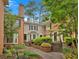 Charming townhome exterior featuring brick accents, green siding, and a beautifully landscaped walkway at 4 Mount Vernon Cir, Atlanta, GA 30338
