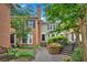 Charming townhome exterior featuring brick accents, green siding, and a beautifully landscaped walkway at 4 Mount Vernon Cir, Atlanta, GA 30338