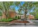 The exterior of the property features brick construction and is surrounded by mature trees and landscaping at 4 Mount Vernon Cir, Atlanta, GA 30338