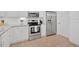 Modern kitchen with stainless steel appliances, white cabinets, and neutral tile floors at 4 Mount Vernon Cir, Atlanta, GA 30338