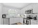 Updated kitchen featuring stainless steel appliances, white cabinetry, and stylish granite countertops at 4 Mount Vernon Cir, Atlanta, GA 30338