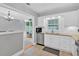 Modern kitchen features white cabinets, stainless steel appliances, and view to the dining area at 4 Mount Vernon Cir, Atlanta, GA 30338