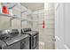 Laundry room with newer front load washer and dryer and plenty of shelving space at 4 Mount Vernon Cir, Atlanta, GA 30338