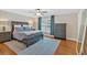 Bright bedroom with hardwood floors, a ceiling fan, and a dark wood dresser at 4 Mount Vernon Cir, Atlanta, GA 30338