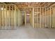 Spacious unfinished basement with stud walls and concrete floor, providing ample room for future expansion at 741 Cams Crk, Mcdonough, GA 30253