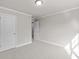 Empty room with plush neutral carpeting, classic lighting, and bright white trim at 741 Cams Crk, Mcdonough, GA 30253