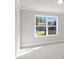Well-lit bedroom featuring neutral paint and large window overlooking the front yard at 741 Cams Crk, Mcdonough, GA 30253