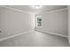 Empty room with plush neutral carpeting, classic lighting, and bright white trim at 741 Cams Crk, Mcdonough, GA 30253