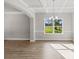 Dining room featuring hardwood floors, coffered ceiling, and elegant chandelier at 741 Cams Crk, Mcdonough, GA 30253