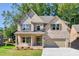 Inviting two-story home with brick facade, well-manicured lawn, covered front porch, and two-car garage at 741 Cams Crk, Mcdonough, GA 30253