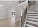 Bright foyer with hardwood floors, staircase, and views into the living and dining areas at 741 Cams Crk, Mcdonough, GA 30253