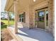Charming covered front porch featuring brick columns and a stylish front door with sidelights at 741 Cams Crk, Mcdonough, GA 30253