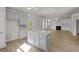 Open-concept kitchen with granite countertops, stainless steel appliances, island, and modern lighting at 741 Cams Crk, Mcdonough, GA 30253