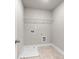 The laundry room with neutral paint, tile floor and utility sink at 741 Cams Crk, Mcdonough, GA 30253