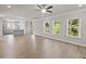 Open concept living room and kitchen featuring wood floors, natural light and modern lighting at 741 Cams Crk, Mcdonough, GA 30253