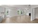 Bright living room featuring wood floors, fireplace, and a multitude of natural light from exterior windows at 741 Cams Crk, Mcdonough, GA 30253