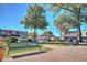 Charming town square featuring benches, trees, and brick walkways under a sunny blue sky at 741 Cams Crk, Mcdonough, GA 30253