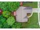 Aerial view of a well-maintained home with a landscaped yard, mature trees, and a driveway at 4235 Crestwood Bend Cir, Buford, GA 30518