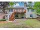 Spacious backyard featuring a deck with stairs, patio, storage shed, swing, lush lawn, and landscaping at 4235 Crestwood Bend Cir, Buford, GA 30518