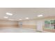 Spacious basement with natural light, neutral-toned walls, modern vinyl plank flooring, and two windows at 4235 Crestwood Bend Cir, Buford, GA 30518