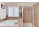 Bathroom featuring a soaking tub and a walk-in shower offering relaxation and convenience at 4235 Crestwood Bend Cir, Buford, GA 30518