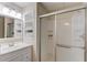 Bathroom featuring white cabinets, a shower stall with sliding glass door, and built-in shelving at 4235 Crestwood Bend Cir, Buford, GA 30518