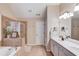 Bathroom with a soaking tub, walk-in shower, tile floors, and double sink vanity at 4235 Crestwood Bend Cir, Buford, GA 30518