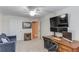 Bedroom featuring a dedicated workspace with desk and large television, as well as a comfortable sitting area at 4235 Crestwood Bend Cir, Buford, GA 30518