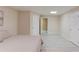 Spacious bedroom featuring light wood floors, neutral paint, and access to an additional room at 4235 Crestwood Bend Cir, Buford, GA 30518