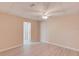 Bedroom featuring a ceiling fan, neutral paint, light wood floors, and an ensuite bathroom at 4235 Crestwood Bend Cir, Buford, GA 30518
