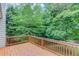 Wooden deck surrounded by mature trees, overlooking the backyard at 4235 Crestwood Bend Cir, Buford, GA 30518