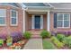 Inviting front porch with brick accents and colorful landscaping detail at 4235 Crestwood Bend Cir, Buford, GA 30518
