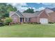 Well-maintained front yard with vibrant flowerbeds that accents the home's facade at 4235 Crestwood Bend Cir, Buford, GA 30518